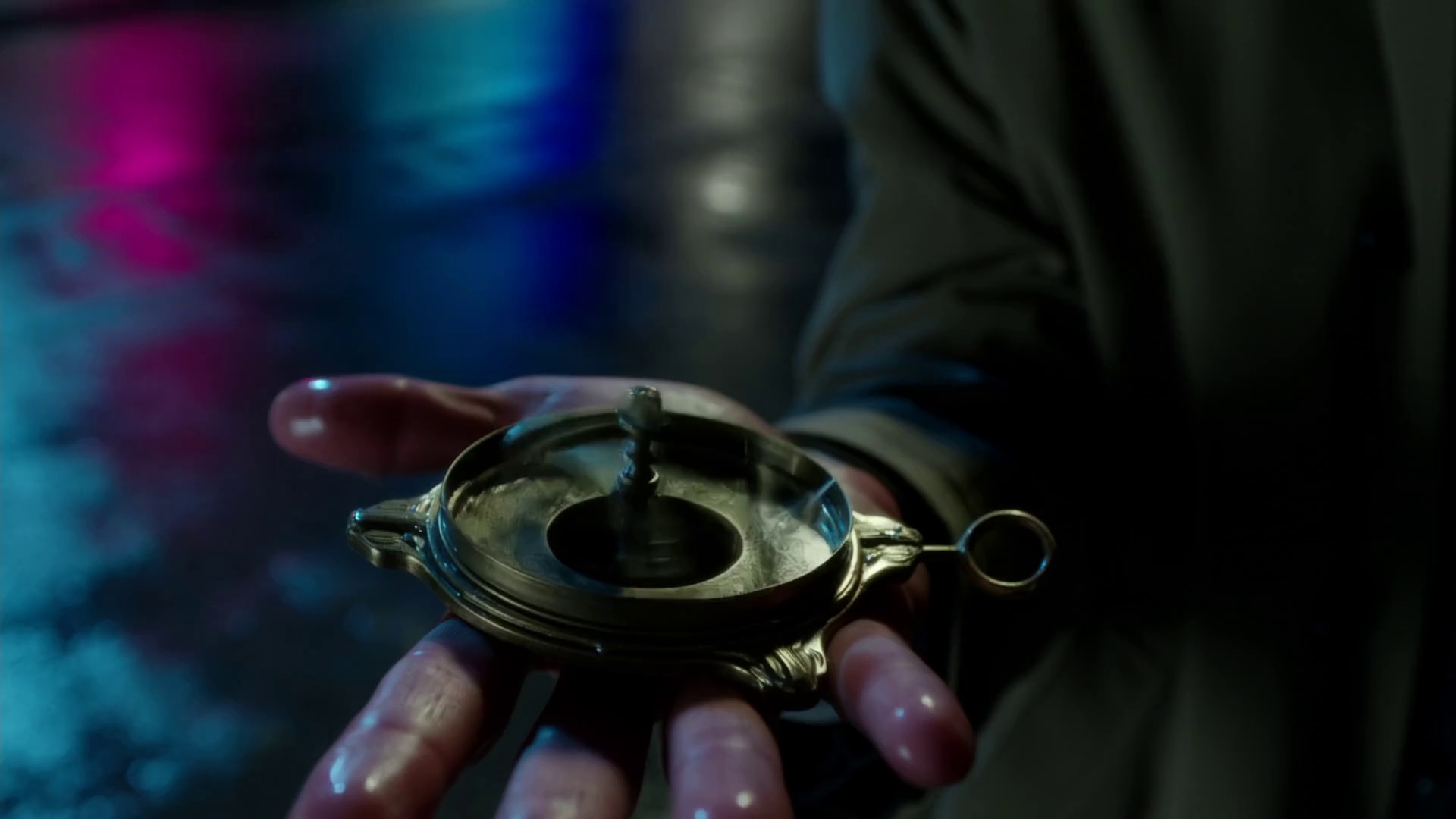 A detective stands on a rainy street corner, looking down at a mysterious brass compass in his palm. The needle is spinning wildly. Camera pulls back from a close-up of the compass to reveal the detective's puzzled face. Film noir, neon reflections on wet streets, heavy shadows.