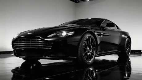 An aggressive, rapid motion, forward, with the tires spinning instantly into a high-speed blur, and the camera pulling back quickly (fast dolly out) as if accelerating away.
