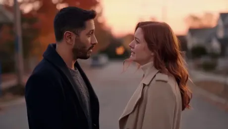 A dramatic Hollywood breakup scene at dusk on a quiet suburban street. A man and a woman in their 30s face each other, speaking softly but emotionally, lips syncing to breakup dialogue. Cinematic lighting, warm sunset tones, shallow depth of field, gentle breeze moving autumn leaves, realistic natural sound, no background music