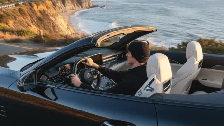 make a photo of the man driving the car down the california coastline