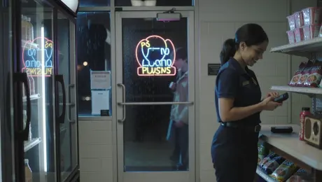 Neon reflections shimmer on the glass door of a small convenience store at night. Inside, a young cashier stacks instant ramen while a tiny radio plays old pop music. Refrigerators hum steadily, and their soft buzzing fills the empty aisles.
A college student walks in, brushing raindrops off his jacket. As he grabs an energy drink, he jokes, "You must think I live here at this point." The cashier laughs: "Third time today. Finals week must be brutal." Their voices feel natural, grounded, mixed with the beeping of the barcode scanner.
As he pays, he sighs, "If I survive this exam, I'm coming back for every snack in this store." The cashier replies, "Deal—just don't drink all the coffee tonight." Rain taps against the glass again as he leaves, the small bell chiming above the door before the scene fades.