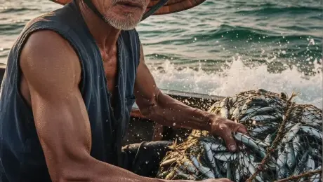 A weathered elderly fisherman with deep wrinkles and sun-kissed skin hauls a heavy rope net teeming with shimmering, flopping silver fish onto the wooden boat. Water droplets and sea spray explode from the mesh net, catching the golden hour light as the fish thrash energetically. The fisherman's muscular arms tense with the strain, his chest heaving slightly as he blinks against the salt mist. The camera executes a dynamic low-angle tracking shot that slowly zooms in on his determined expression, incorporating a subtle handheld shake to simulate the rocking motion of the boat on the turbulent turquoise waves. In the background, distant limestone islands sit under a hazy sun, with light glinting off the water's surface. 4k, 60fps, slow motion splashes, highly detailed skin textures, cinematic color grading, volumetric lighting, photorealistic.