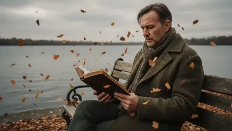 Retain the middle-aged man's thoughtful expression and seated posture on the wooden park bench by the lake. Replace his olive green wool coat with a heavy navy blue down parka featuring a grey faux-fur lining around the collar. Swap the brown scarf for a vibrant crimson chunky-knit wool scarf. Replace all swirling orange autumn leaves with delicate, crystalline white snowflakes of varying sizes drifting through the air. Add a thin, textured layer of powdery snow on the bench slats, the man’s shoulders, and the ground. Replace the old hardcover book in his hands with a slim, metallic silver digital tablet that emits a soft cyan glow onto his face, showing a holographic UI with futuristic text. Change the background lighting from a warm overcast to a cool, dim winter twilight with a pale blue-grey sky reflected in the partially frozen lake. Add a subtle misty breath effect near the man's mouth. High-definition realistic photography style, 8k resolution, sharp focus on the man and tablet, cinematic cold color palette.