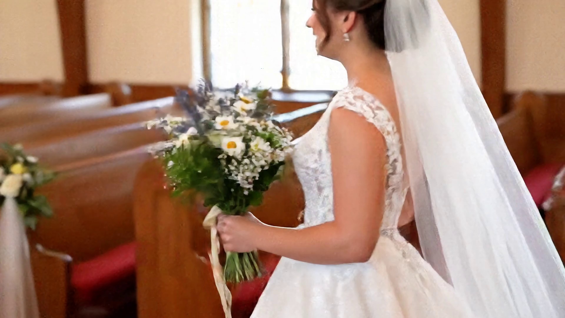 On the church aisle, the bride held a bouquet and walked toward her groom, saying to him, "I do."