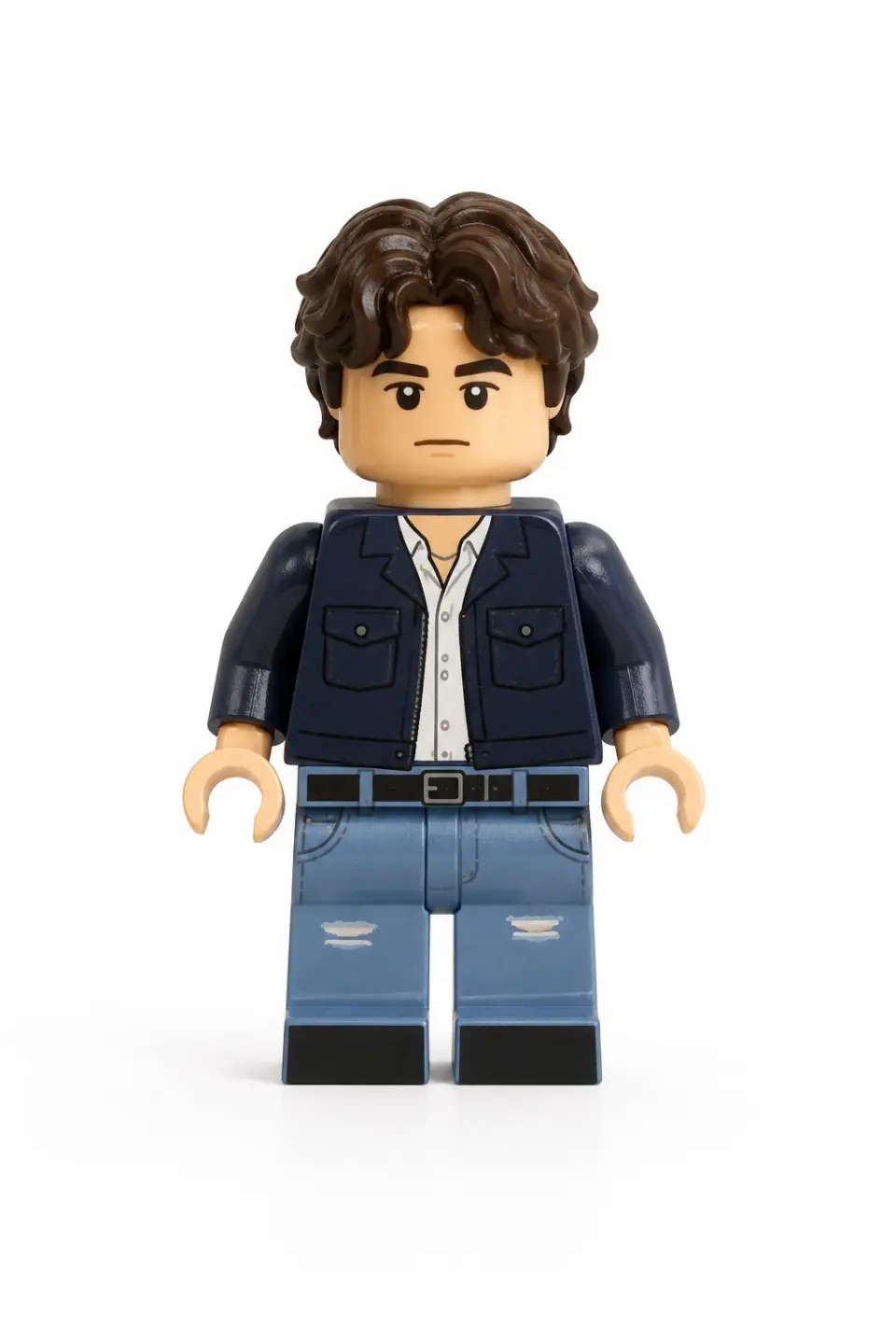 Use the user uploaded image as the only subject reference. Transform the person in the uploaded image into a realistic LEGO style minifigure while preserving their recognizable identity and outfit. Preserve the subject's facial likeness as much as possible within LEGO minifigure design limits, maintaining the same hairstyle and hair color adapted into a LEGO hairpiece, facial expression, clothing colors, clothing design and patterns, and any visible accessories. The result should clearly represent the same person translated into LEGO form. The character must follow authentic LEGO minifigure proportions, including a cylindrical yellow or skin tone LEGO style head, simple printed facial features adapted from the subject, a block shaped torso with printed clothing details, standard LEGO minifigure arms with curved hands, short LEGO minifigure legs, and a distinct molded plastic hairpiece matching the subject's hairstyle.
Render the figure using realistic LEGO plastic material with a slight glossy sheen, subtle molded seams, and natural toy surface reflections. The face and torso should include printed details typical of LEGO minifigures, and the hairpiece should appear as molded plastic. The final image should be a high quality realistic 3D toy render with soft diffused studio lighting, subtle shadows that emphasize shape and plastic texture, and clean sharp focus with crisp detail. The framing must show the full body minifigure from head to feet in a centered composition with the entire figure fully visible. Use a plain white background with no scenery, no props, and no additional elements. The final style should feel like a photorealistic LEGO minifigure toy render with highly detailed plastic texture and studio lighting.